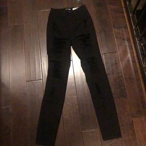 Women’s fashion nova distressed skinny jeans.